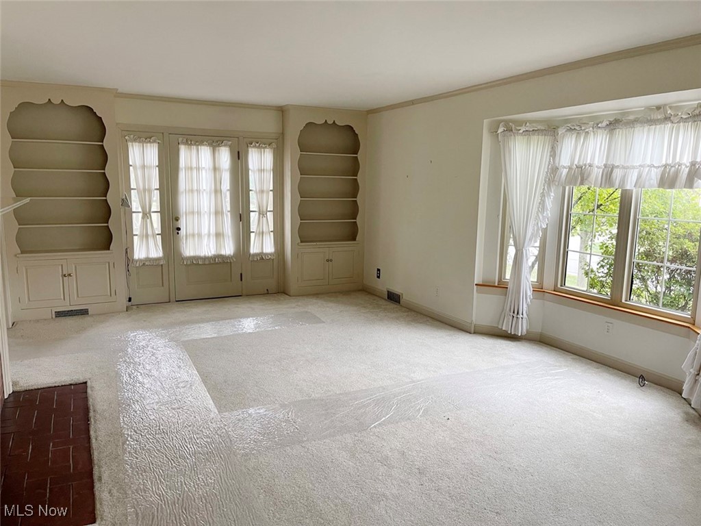 2702 Martin Road Zanesville, OH 43701 - Photo 12 of 34 Unfurnished room with ornamental molding and light carpet