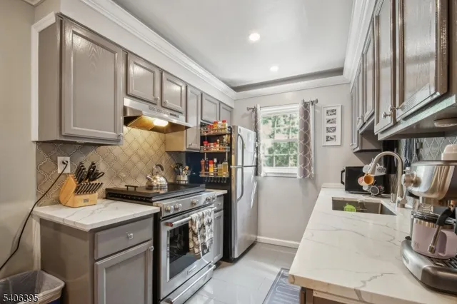 a kitchen with a stove a refrigerator and a sink