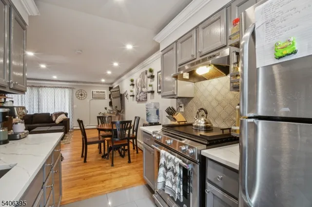 a kitchen with stainless steel appliances granite countertop a refrigerator and a stove