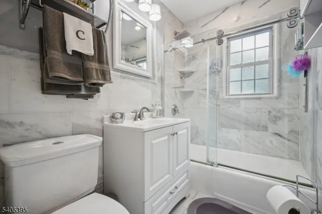 a bathroom with a toilet sink and shower