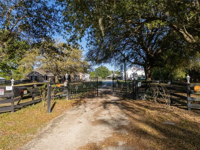 a living room with furniture a fireplace and a large window