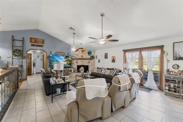 a view of a dining room with furniture a chandelier and wooden floor