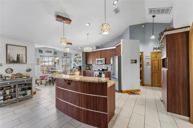 a view of a dining room with furniture a chandelier and wooden floor