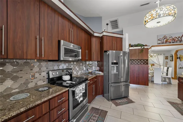 a view of a livingroom with workspace and a window