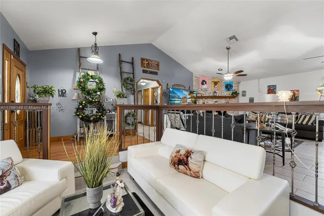 a living room with furniture and flowers