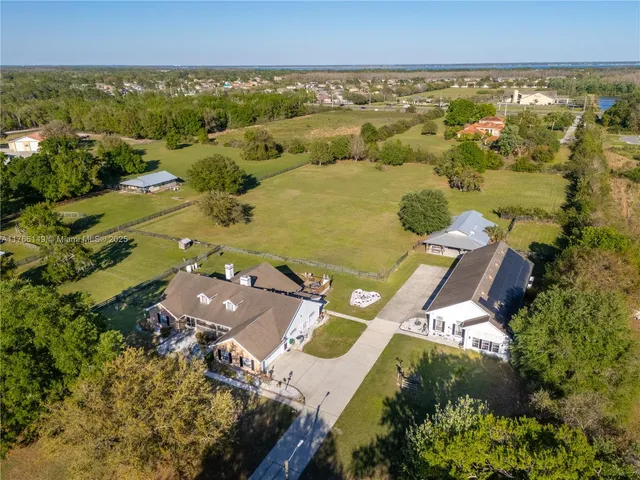 a view of a house with pool yard and outdoor seating