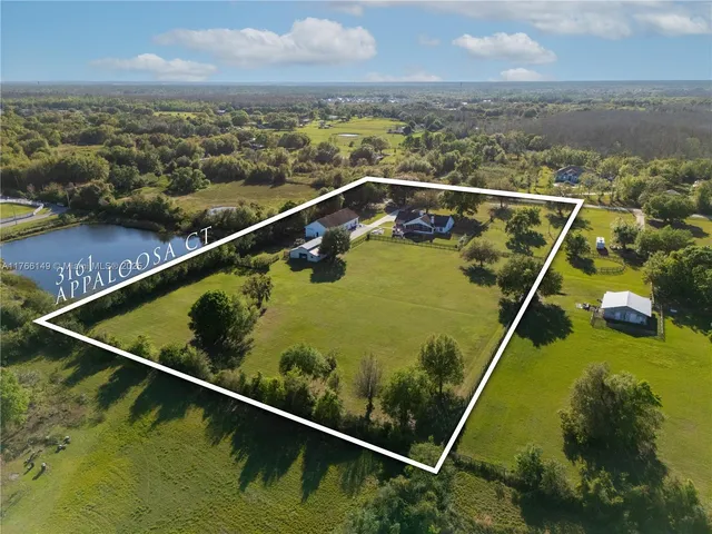 an aerial view of a house with garden space and ocean view