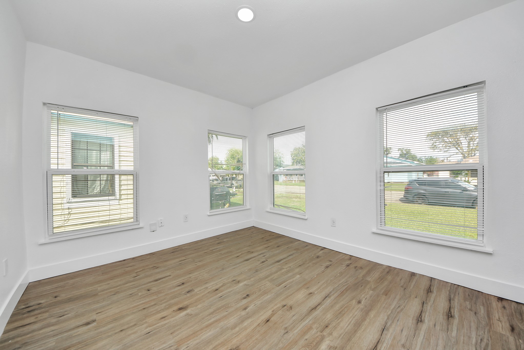 1203 West 6th Street Freeport, TX 77541 - Photo 12 of 50 a view of an empty room with wooden floor and a window