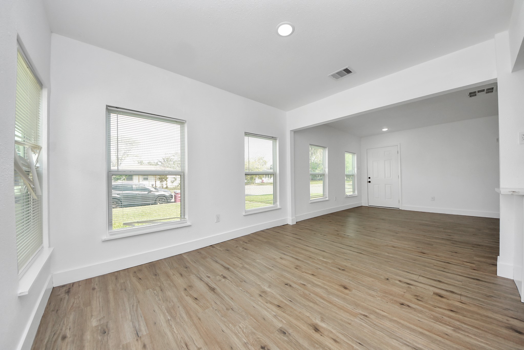1203 West 6th Street Freeport, TX 77541 - Photo 13 of 50 an empty room with wooden floor and windows