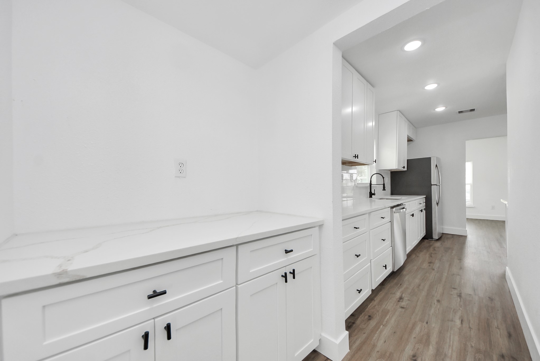 1203 West 6th Street Freeport, TX 77541 - Photo 23 of 50 a kitchen with cabinets and wooden floor