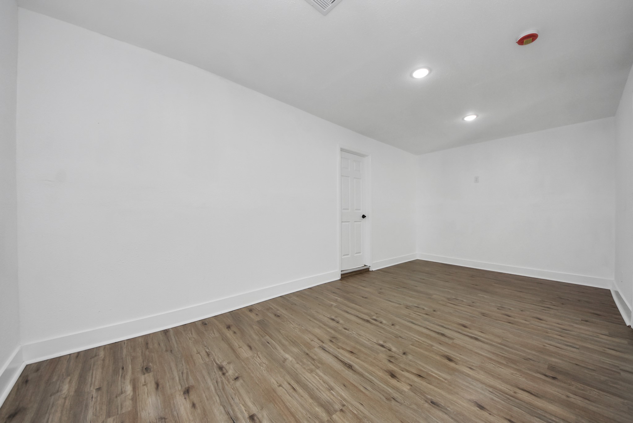 1203 West 6th Street Freeport, TX 77541 - Photo 27 of 50 a view of an empty room with wooden floor