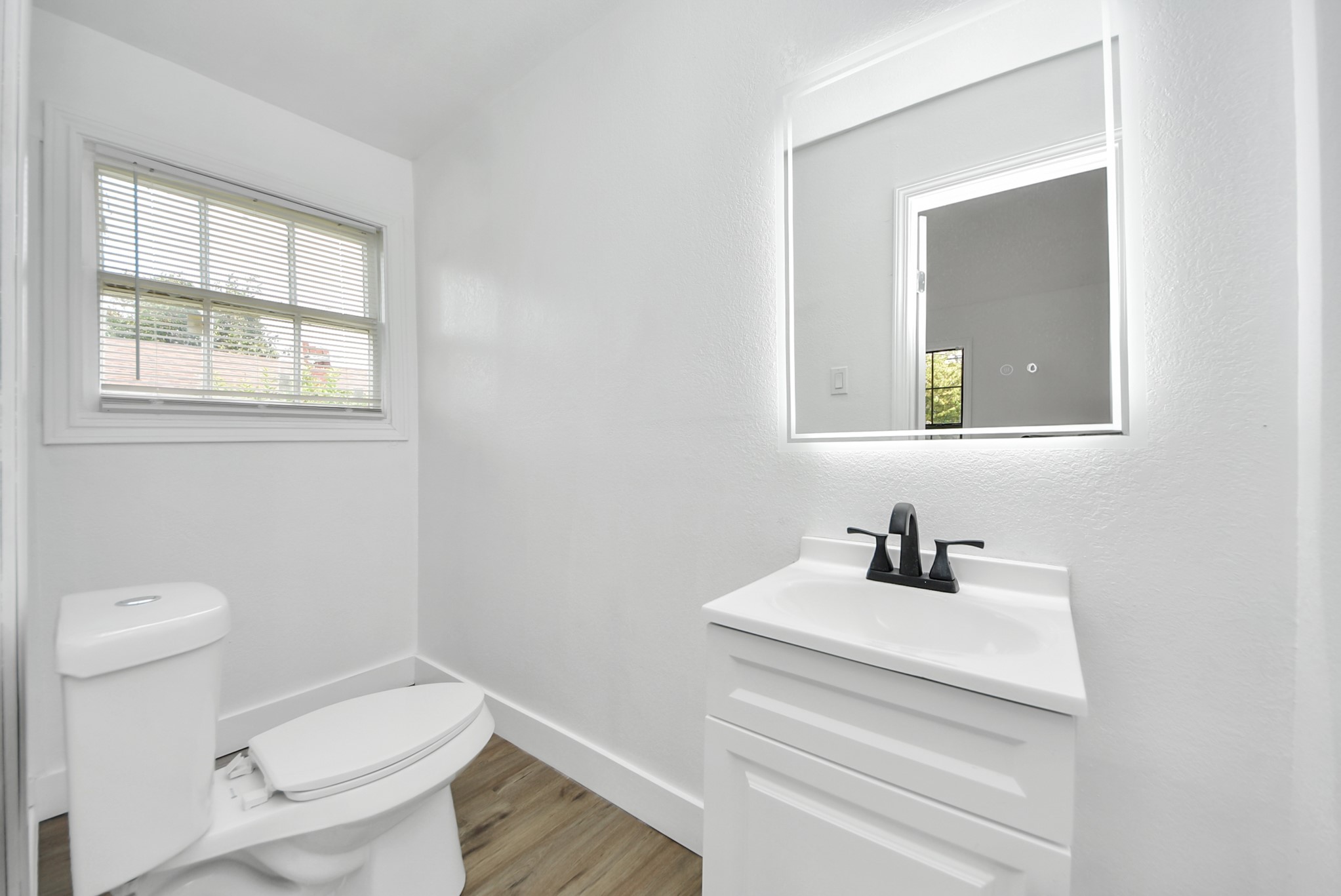 1203 West 6th Street Freeport, TX 77541 - Photo 36 of 50 a bathroom with a toilet sink and mirror