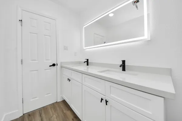 a bathroom with a sink and mirror