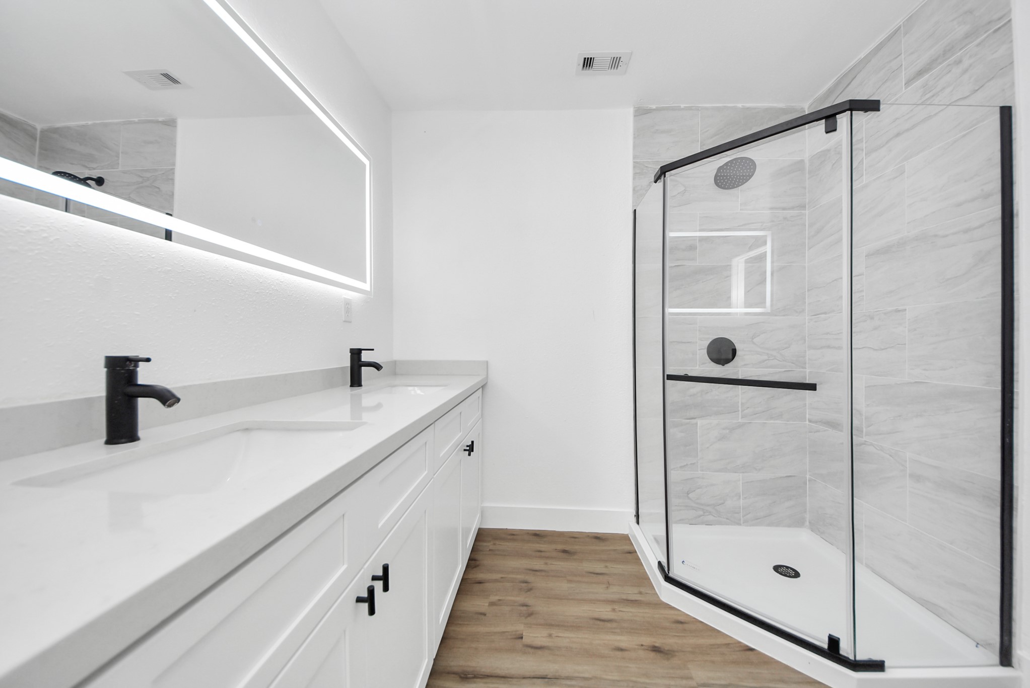 1203 West 6th Street Freeport, TX 77541 - Photo 47 of 50 a bathroom with a shower sink and mirror
