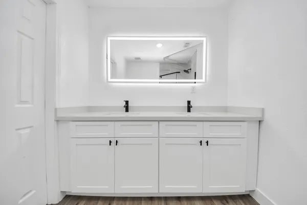a bathroom with a sink and a mirror