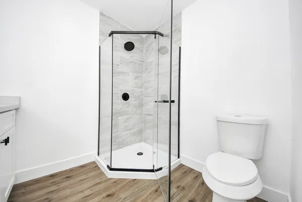 a bathroom with a toilet and a shower