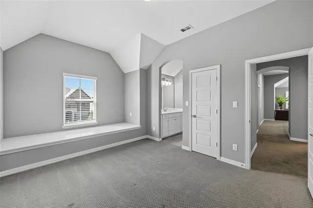 an empty room with windows and entrance