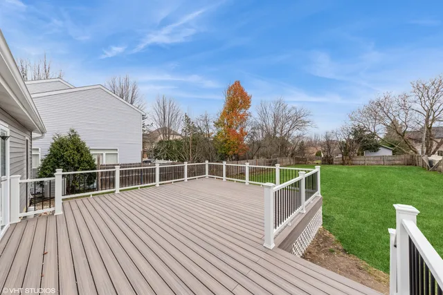 a view of a roof deck with couches and wooden floor