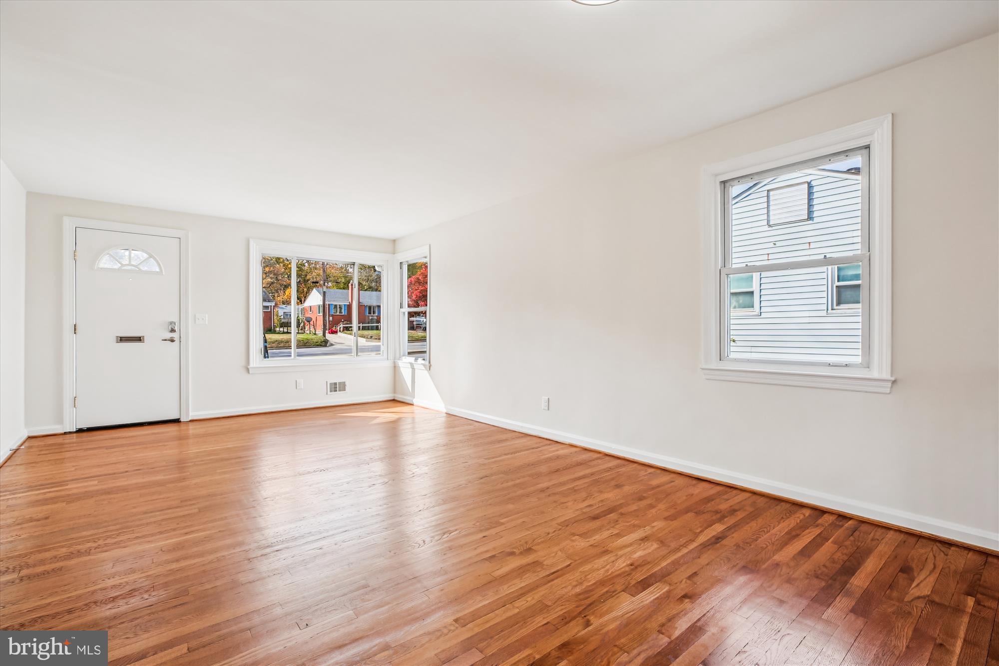 11603 Veirs Mill Road Silver Spring, MD 20902 - Photo 13 of 48 an empty room with wooden floor and windows