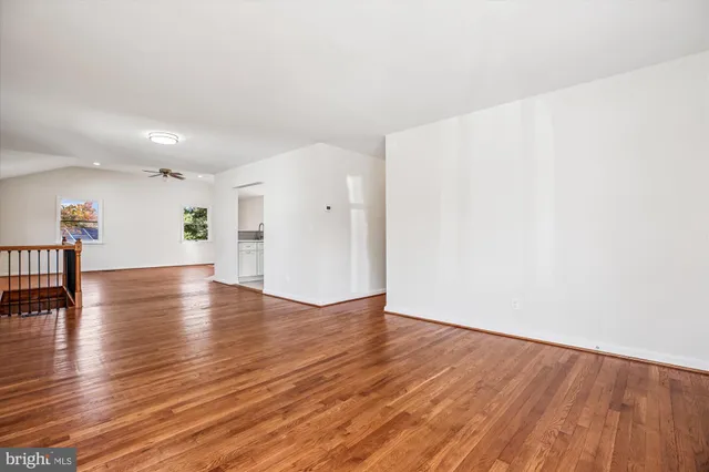 a view of empty room with wooden floor