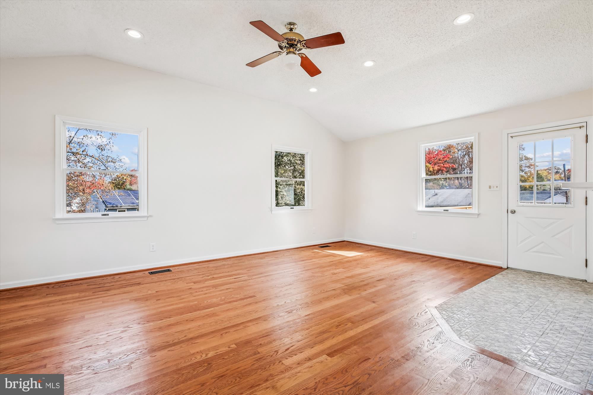 11603 Veirs Mill Road Silver Spring, MD 20902 - Photo 17 of 48 a view of a big room with wooden floor and a ceiling fan