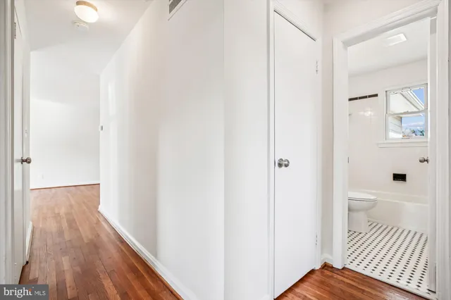 a view of a hallway with wooden floor