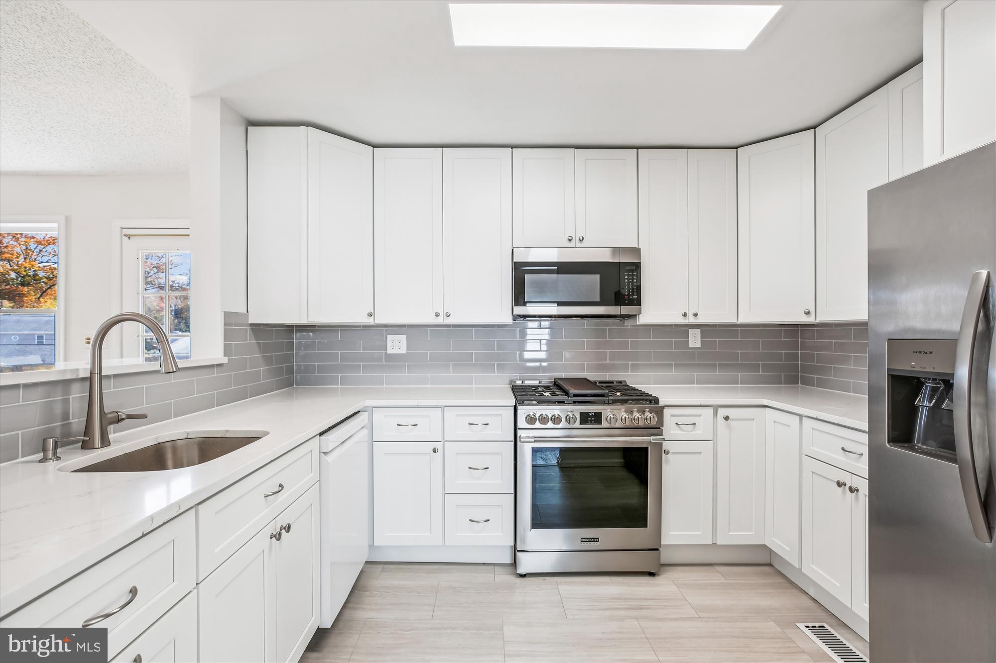 11603 Veirs Mill Road Silver Spring, MD 20902 - Photo 20 of 48 a kitchen with white cabinets and stainless steel appliances