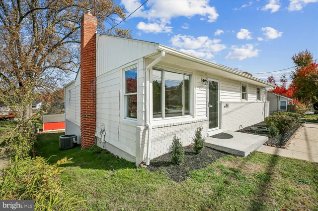 a view of backyard of house with green space