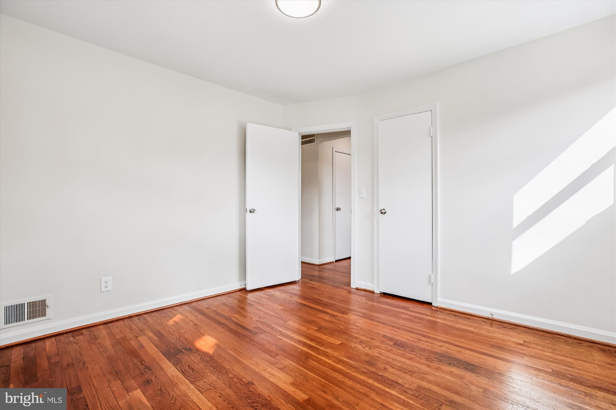 11603 Veirs Mill Road Silver Spring, MD 20902 - Photo 27 of 48 a view of an empty room with wooden floor