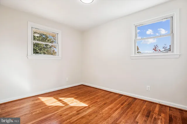 a view of a room with wooden floor and window