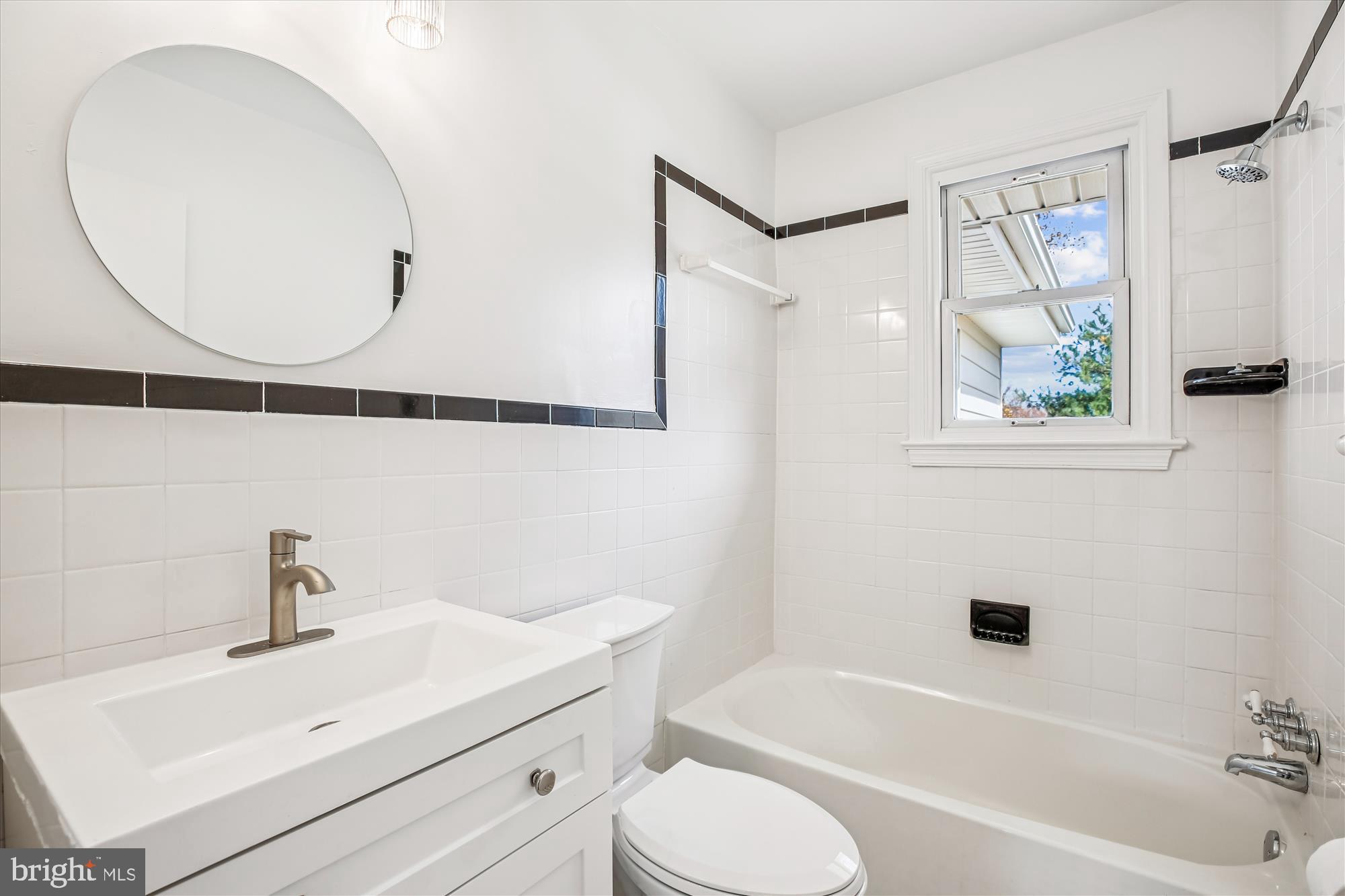 11603 Veirs Mill Road Silver Spring, MD 20902 - Photo 30 of 48 a bathroom with a sink a toilet and a mirror