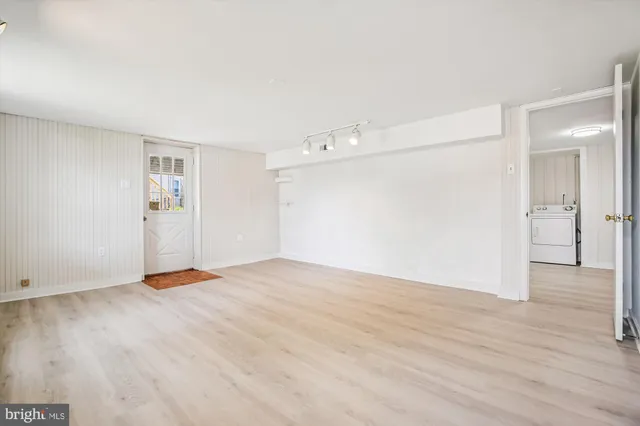a view of an empty room with wooden floor