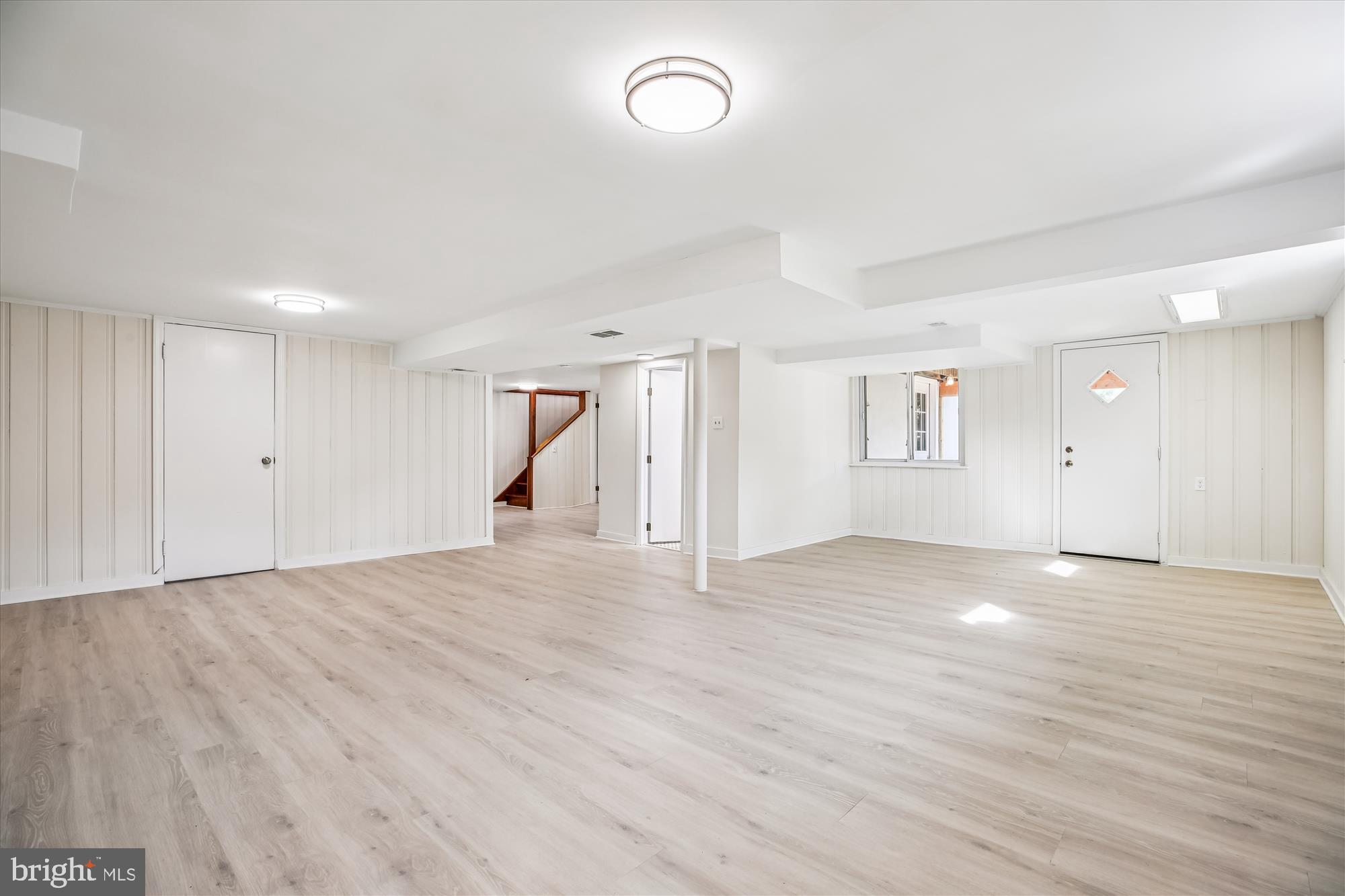 11603 Veirs Mill Road Silver Spring, MD 20902 - Photo 40 of 48 a view of an empty room with wooden floor and a window