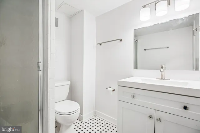 a bathroom with a sink a toilet and a mirror