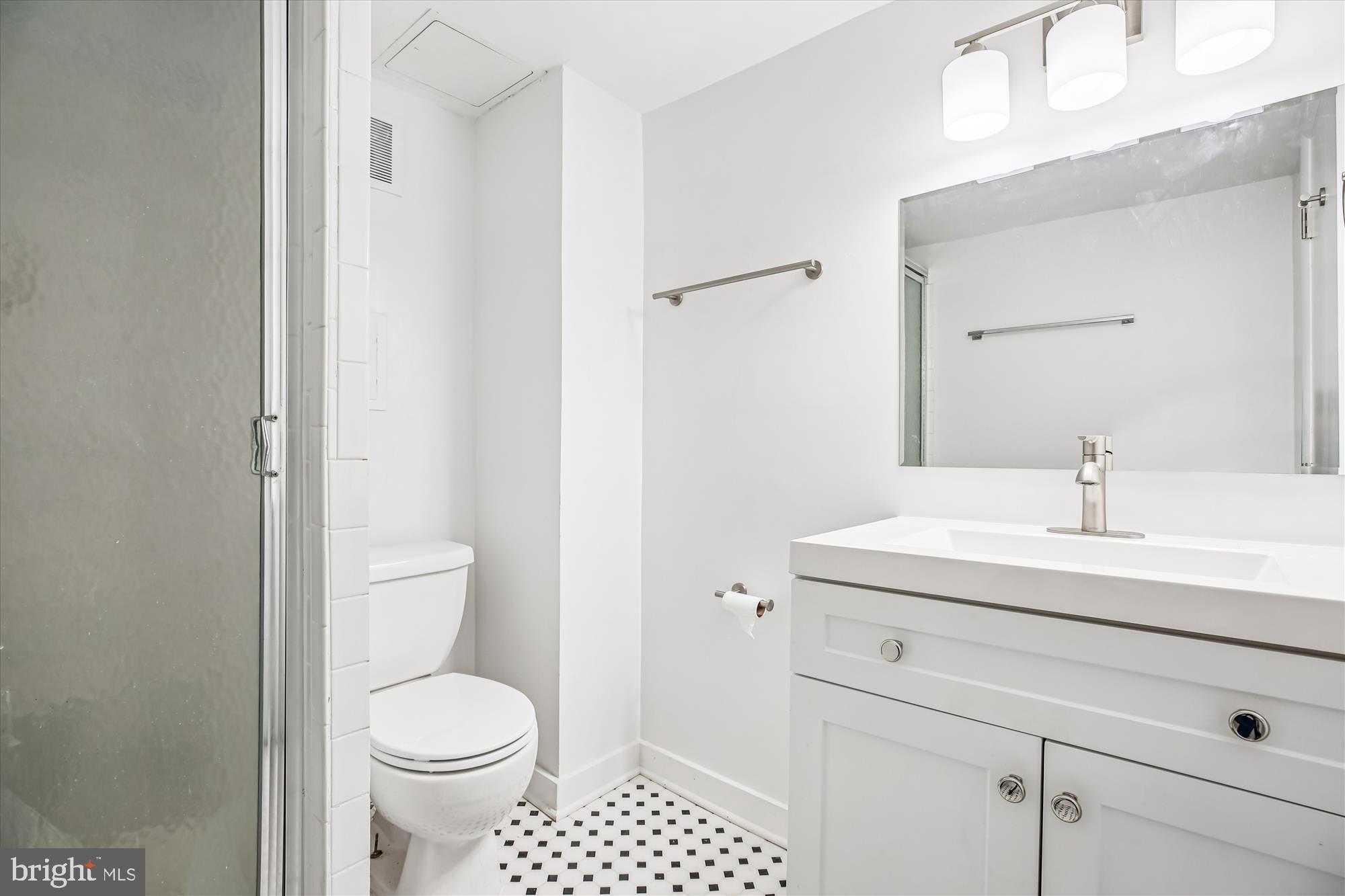 11603 Veirs Mill Road Silver Spring, MD 20902 - Photo 43 of 48 a bathroom with a sink a toilet and a mirror