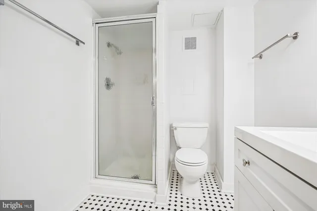 a bathroom with a toilet a sink and a shower