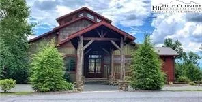 a front view of a house with plants