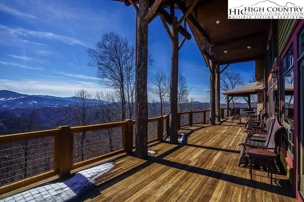 a view of balcony with wooden floor and wooden fence
