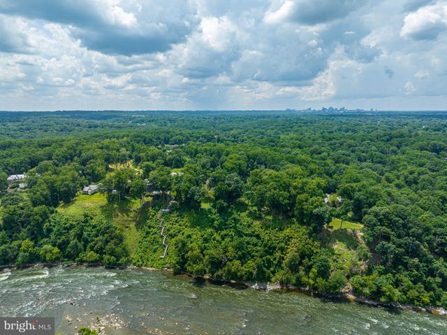 an aerial view of residential houses with outdoor space and trees all around