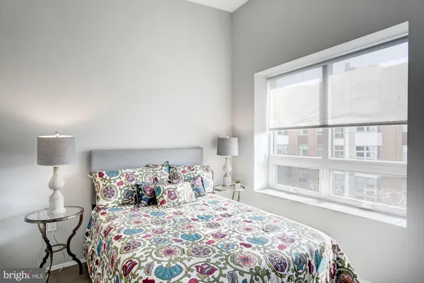 a bedroom with a bed and a window