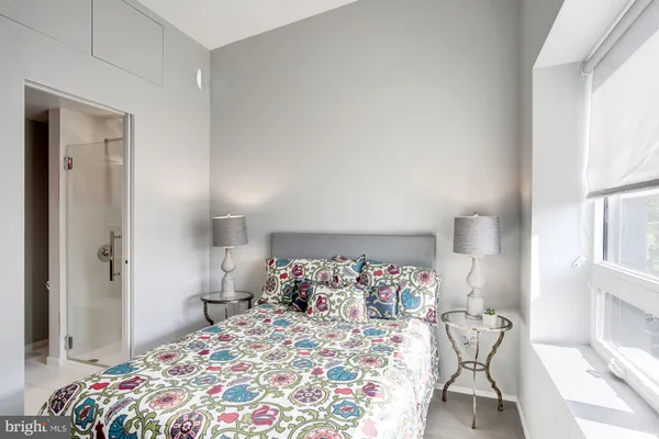 a bedroom with a bed and a window