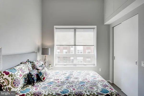 a bed room with a bed and a window