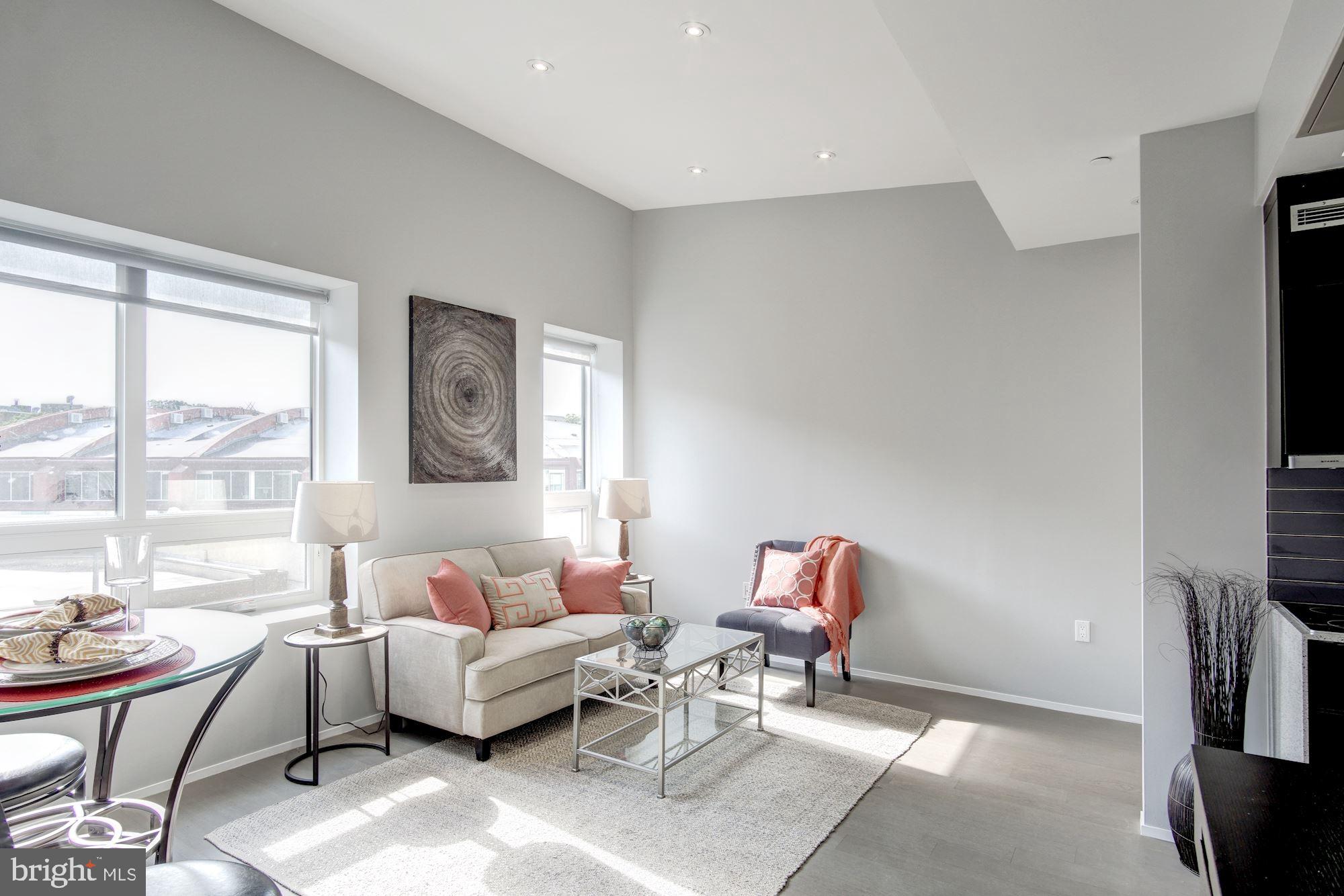2422-2424 17th Street Northwest, Unit 301 Washington, DC 20009 - Photo 5 of 31 a living room with furniture and a flat screen tv