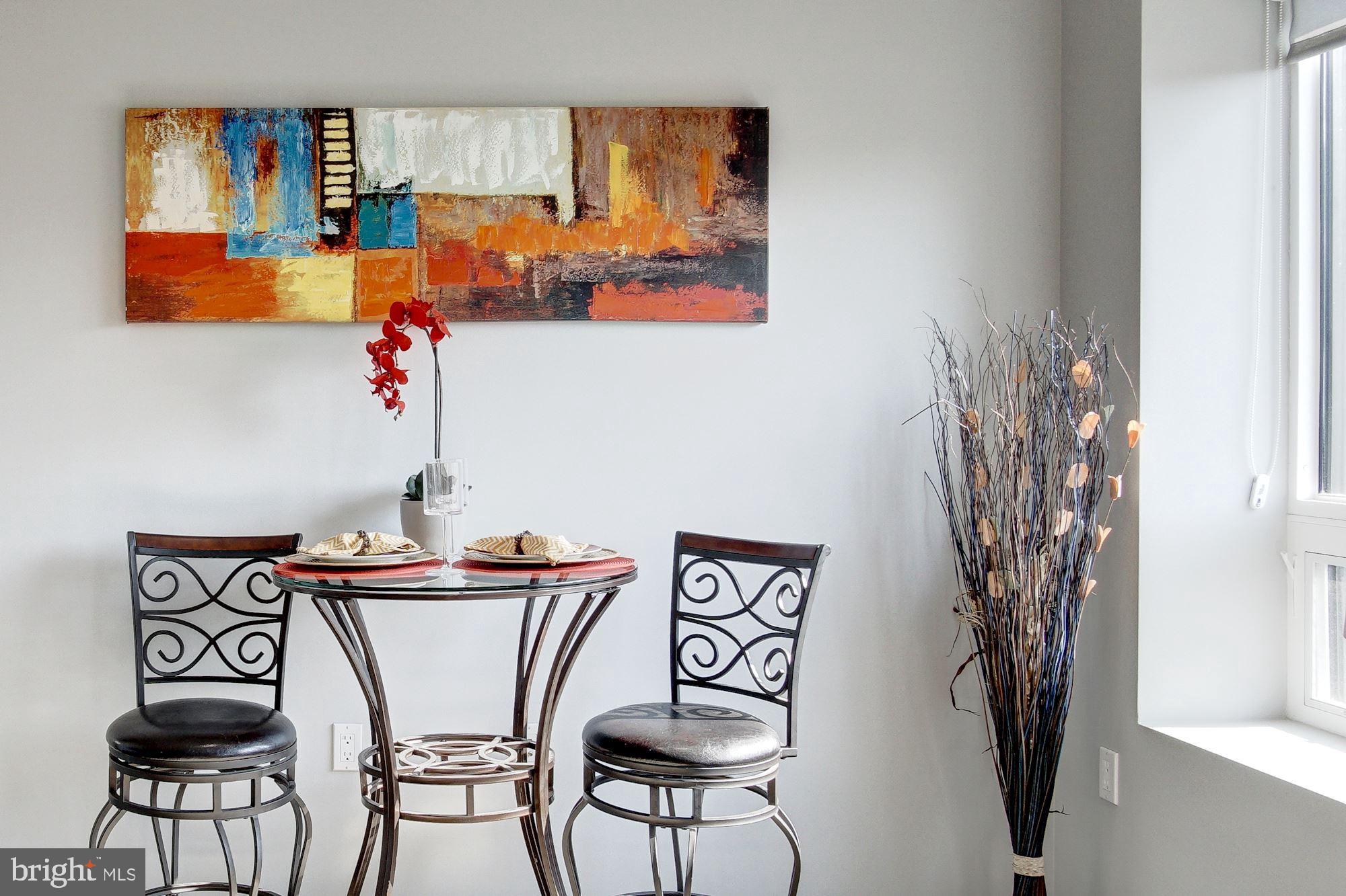 2422-2424 17th Street Northwest, Unit 301 Washington, DC 20009 - Photo 9 of 31 a view of a dining room with furniture and a potted plant