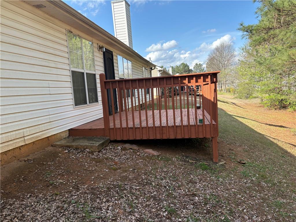 5975 Hillvale Trail Lithonia, GA 30058 - Photo 2 of 10 a view of a roof deck with wooden floor and fence