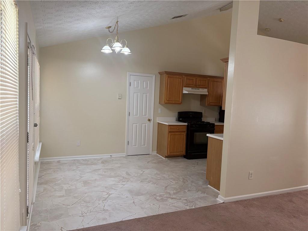 5975 Hillvale Trail Lithonia, GA 30058 - Photo 3 of 10 a view of a kitchen with a sink cabinets and a window
