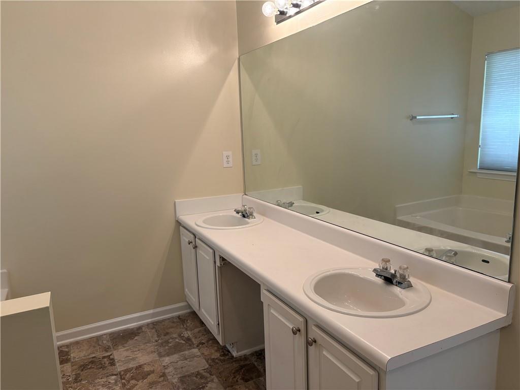 5975 Hillvale Trail Lithonia, GA 30058 - Photo 5 of 10 a bathroom with a sink and a mirror