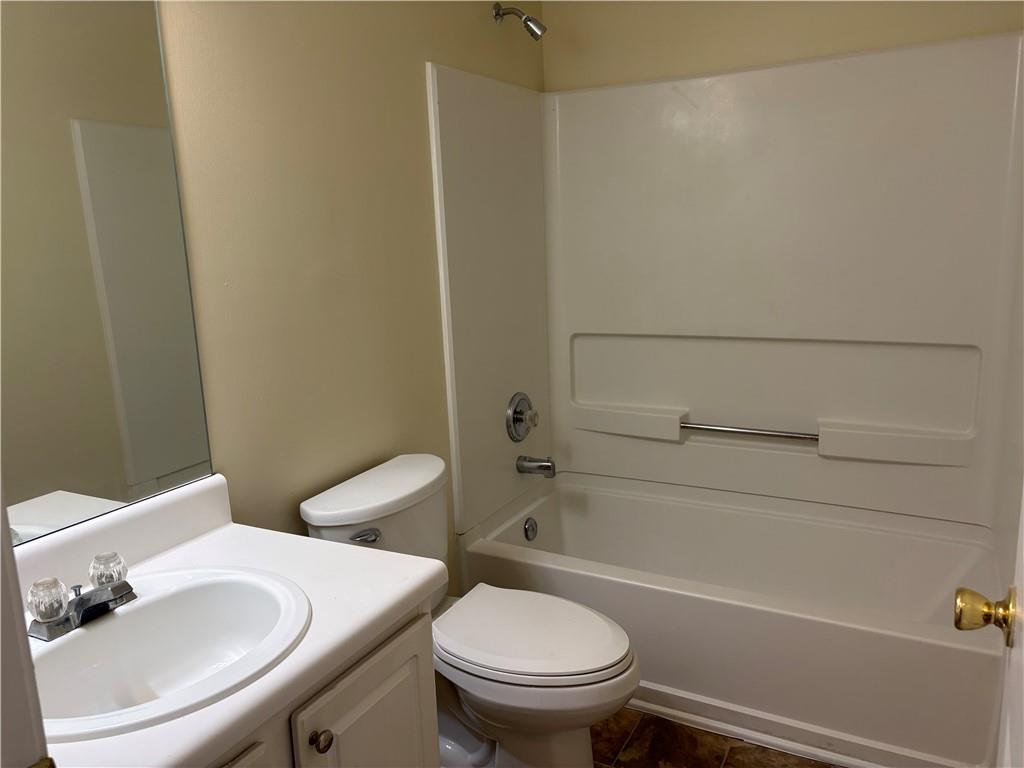 5975 Hillvale Trail Lithonia, GA 30058 - Photo 7 of 10 a bathroom with a sink toilet and a bathtub