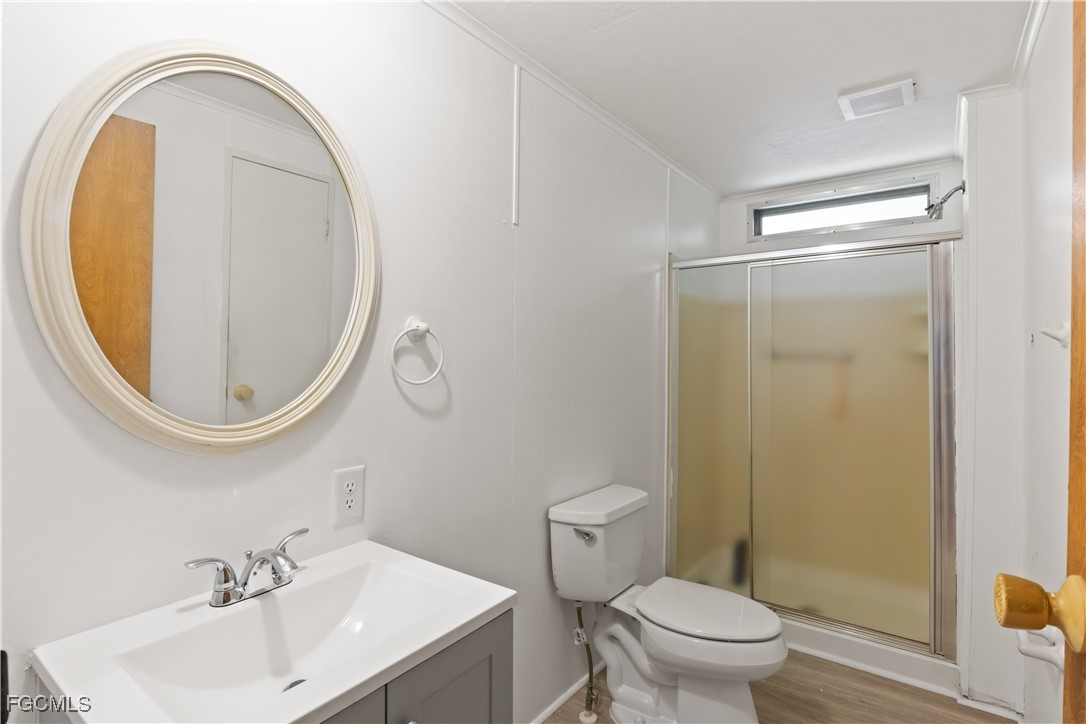 15550 Burnt Store Road, Unit 229 Punta Gorda, FL 33955 - Photo 18 of 41 a bathroom with a sink mirror toilet and vanity