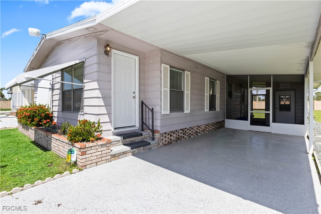 15550 Burnt Store Road, Unit 229 Punta Gorda, FL 33955 - Photo 3 of 41 a view of a house with backyard and garden